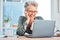 Laptop, coffee and senior business woman laughing at an email in her office at work for fun or humor. Computer, tea and