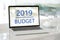 Laptop computer with 2019 budget on screen background, digital m