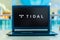 Laptop computer displaying logo of Tidal