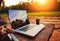 Laptop computer on rough wooden table with coffee cup and bouquet of peonies flowers in outdoor park