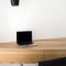 Laptop on corner wooden desk