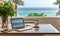 Laptop and a cup of coffee on table on a balcony with ocean view with copy space