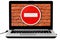 Laptop with the DO NOT ENTER road sign and a red brick wall on the screen