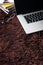 Laptop,eyeglasses and books on carpet