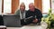 Laptop, finance and senior couple on a sofa with documents for tax, planning or savings at home. Budget, investment and