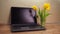 Laptop with flowers. Laptop in the kitchen. There is a laptop on the marble kitchen table.