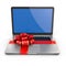 Laptop gift. Bow and ribbon on keyboard