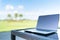 Laptop on golf course blur background with copy space, business or work from anywhere concept, depth of field effect