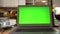 Laptop with green screen on the kitchen table