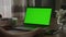 Laptop with green screen. Pivoting around unrecognisable woman watching computer with chroma key