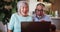 Laptop, hello and senior couple on video call in home, smile or talk in communication. Wave, man and woman in virtual