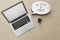 Laptop, houseplant and speech bubble with hashtag STAY AT HOME on wooden background, flat lay. Message to promote self-isolation