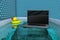 Laptop inside in the bathtub with a yellow rubber duck beside