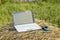 laptop with modem lies on a haystack in a meadow evening at sundown