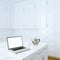 Laptop and Morning Coffee in White Classic Kitchen Interior