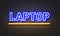 Laptop neon sign on brick wall background.