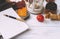 Laptop, Notepad, pen, pumpkins, candle, maple dry fallen leaves on a white wooden table