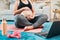 Laptop, pregnant woman and yoga or pilates in living room, motivation for fitness and health from home. Exercise