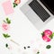 Laptop, roses flowers, diary, pen, envelope and marshmallow on white background. Flat lay. Top view. Business composition