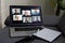 Laptop screen with multi-person conference, collage of group of multiracial people, webcam view, video chat. A lot of