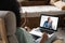 Laptop screen over woman shoulder view, communication group videocall conversation