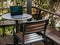 laptop sits on the wooden table on the balcony, creating a harmonious blend of technology and nature,as the gentle breeze and