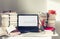 Laptop, stack of books, notebooks and pencils on white table, education office concept background