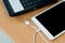 Laptop tablet and usb cable on wooden desk