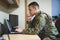 Laptop, thinking and military man with security software, online research and law academy in office. Planning, soldier