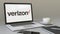 Laptop with Verizon Communications logo on the screen. Modern workplace conceptual editorial 3D rendering