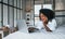 With laptop. Young african american woman with curly hair indoors at home