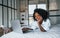 With laptop. Young african american woman with curly hair indoors at home