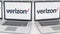 Laptops with Verizon Communications logo on the screen. Computer technology conceptual editorial 4K clip, seamless loop
