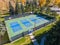 Laramie Wyoming Tennis Court in a City Park  surrounded by tall pine trees, during Sunny Fall Day