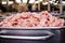 Lard, pork or ground beef in metal containers in food production at a meat processing plant.