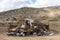 Large abandoned dilapidated recreational vehicle dumped in the desert