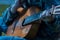 A large acoustic old guitar in the hands