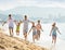 Large active family happily running on beach