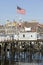 Large American flag flies in Portland Harbor with south Portland skyline, Portland, Maine