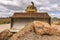 Large amount of stone and earth moved by a yellow excavator