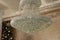 Large antique crystal chandelier in loft style interior. Soft side-by-side focus