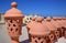 Large Arabic-looking lamps made of red baked clay are for sale in a market