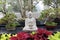 Large Asian Statue Sitting In An Indoor Zen Garden At The Botanical Gardens In Buffalo NY.