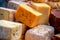 large assortment of international cheese specialities on black background