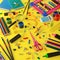 Large assortment school supplies on yellow background.