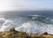 Large Atlantic waves hit the high cliffs when the sun shines.