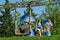 Large baby heads with smiling faces in mirrored metal. Sculpture installation Inner Child by sculptor Ken Kellehe