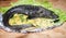 Large baked Russian sturgeon with caviar and lettuce leaves on w