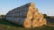 Large bales of hay are stacked for storage