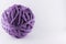 A large ball of violet wool. Cozy accessories. Materials for knitting